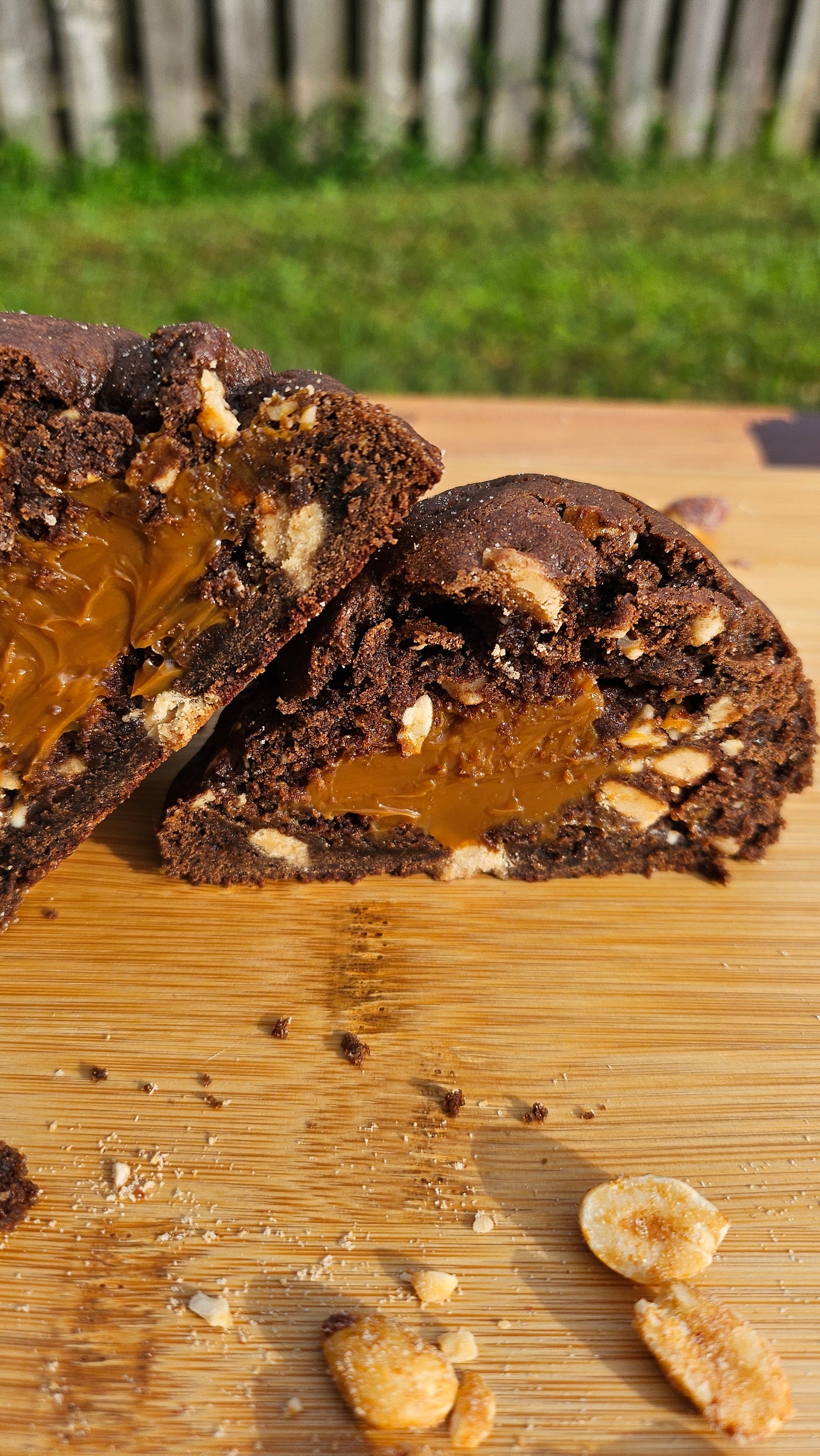 "Snicker cookie stuffed with melted caramel and peanut butter chips, offering a deliciously sweet and nutty flavor in every bite."