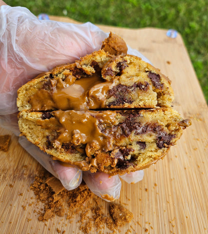 "Close-up of homemade Biscoff cookies, golden brown with a crisp finish and a hint of cinnamon. Topped with more cookie butter drizzle.