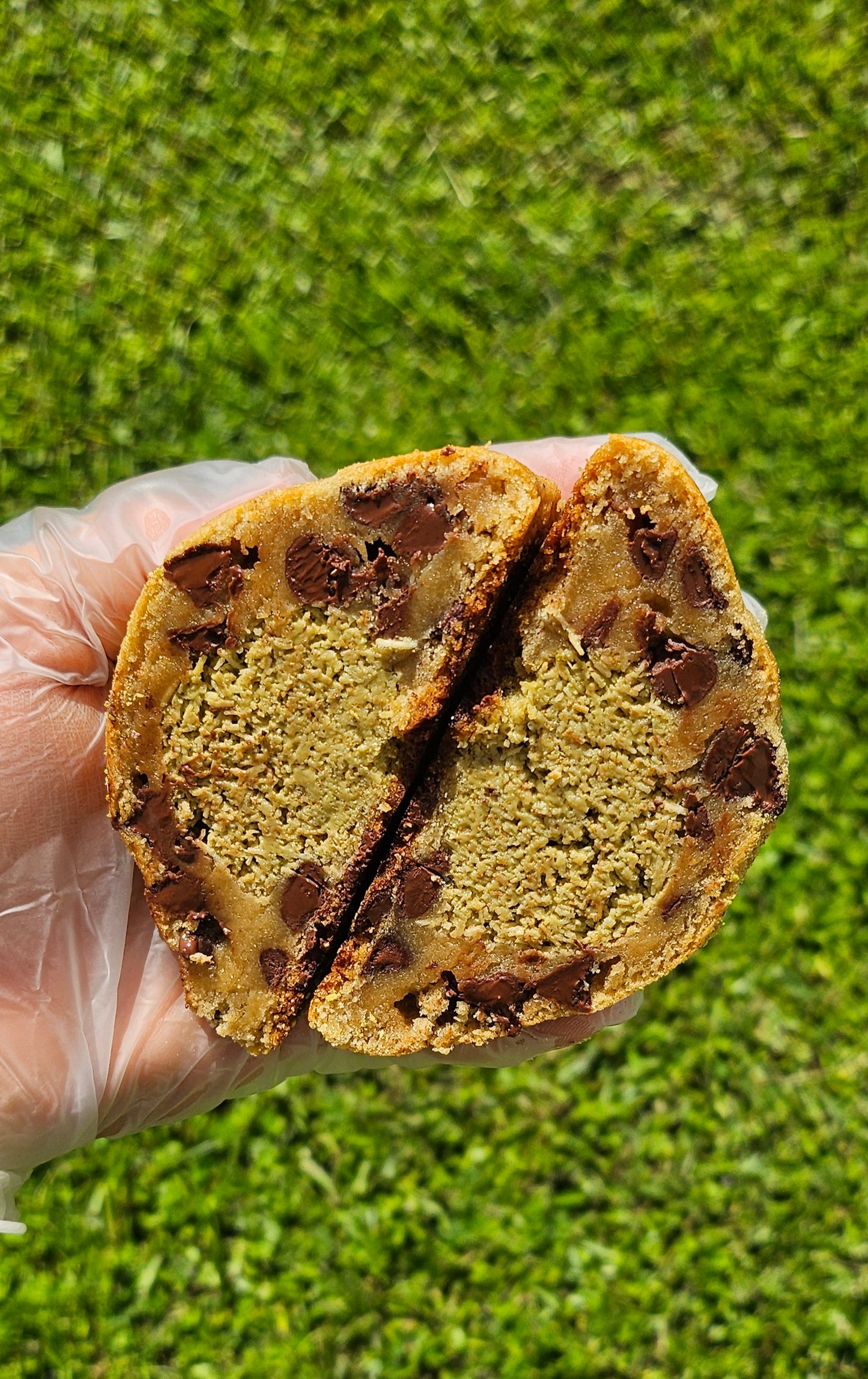 "Close-up of homemade pistachio cookies with a golden-brown crust. stuffed with pistachio kunefe and toasted pistachios."
