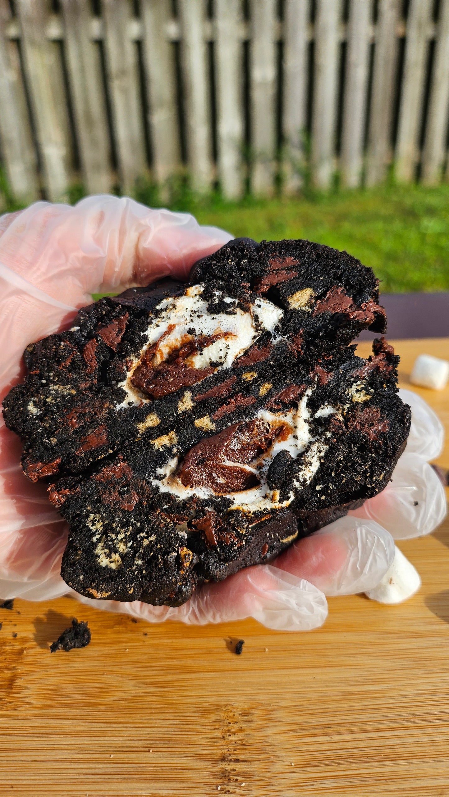 "Delicious black velvet s'mores cookie featuring dark cocoa, marshmallow filling, and crushed graham crackers."
