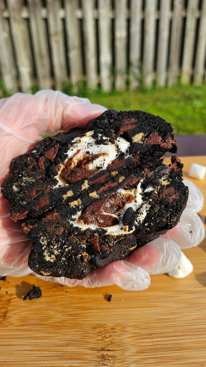 "Delicious black velvet s'mores cookie featuring dark cocoa, marshmallow filling, and crushed graham crackers."
