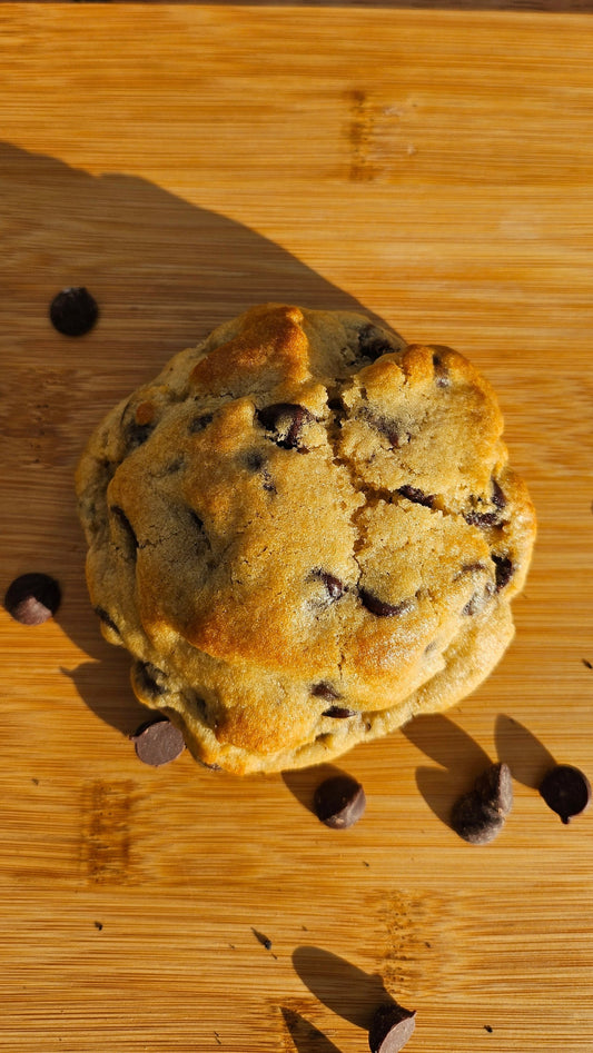 "Golden-brown homemade chocolate chip cookies with a soft center and generously filled with chocolate chips."
