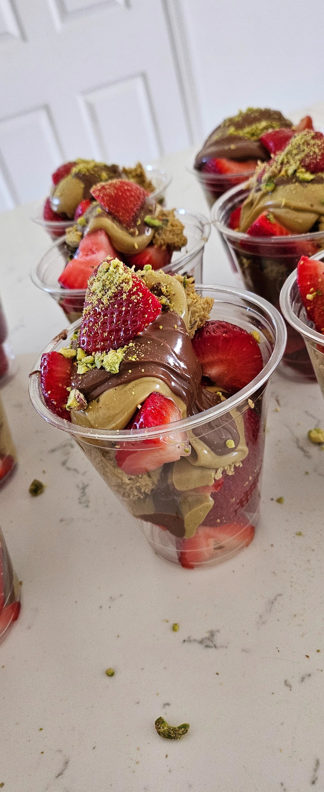 Layered Dubai chocolate strawberry cup with pistachio kataifi and Nutella